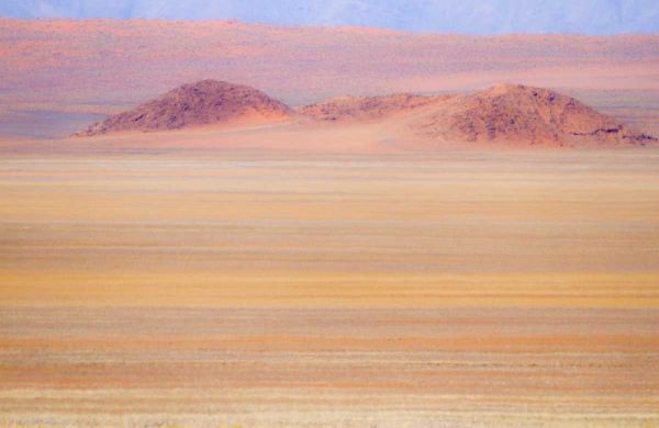 Namibia Heat distorts grassy plain and dunes